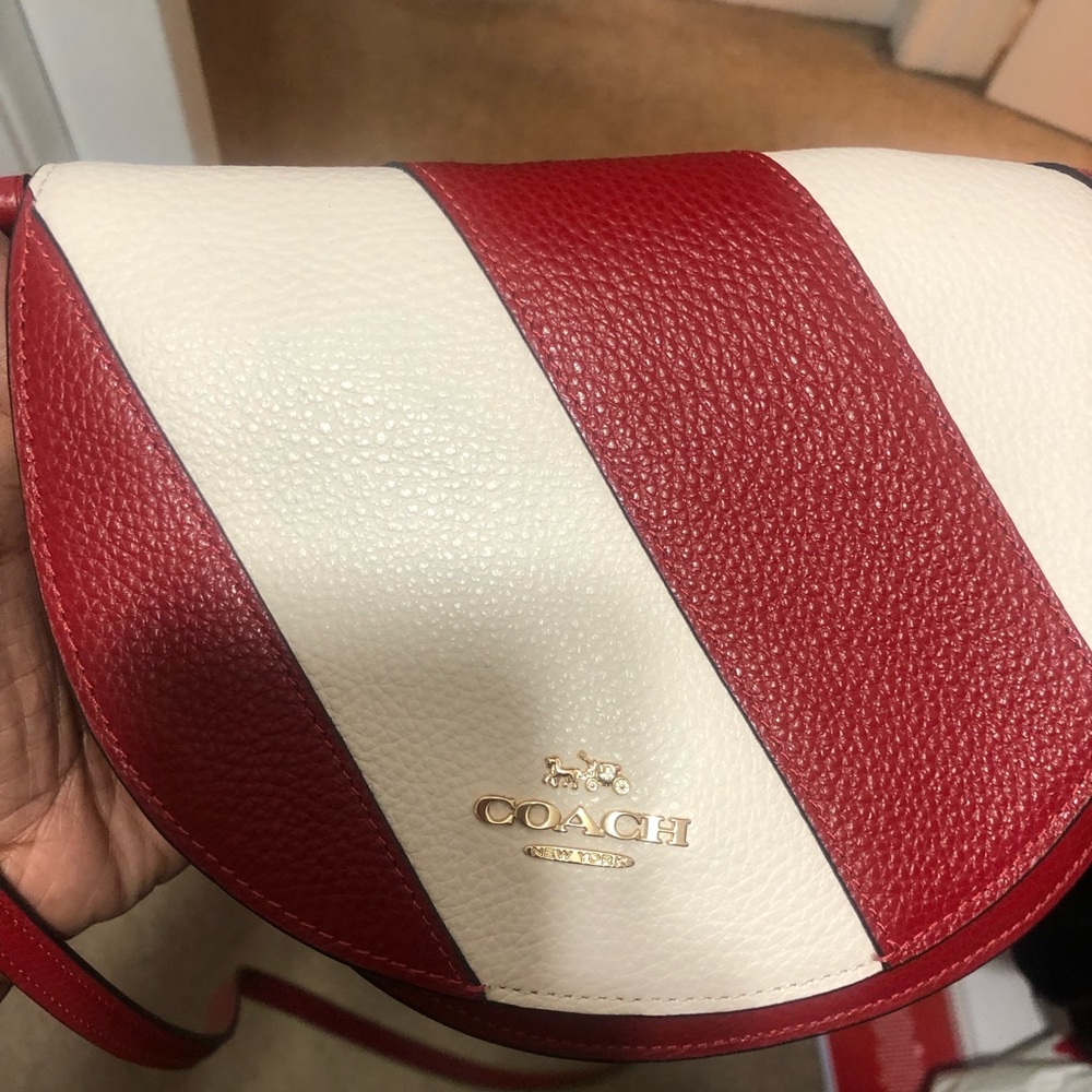 Red and white Coach crossbody bag.